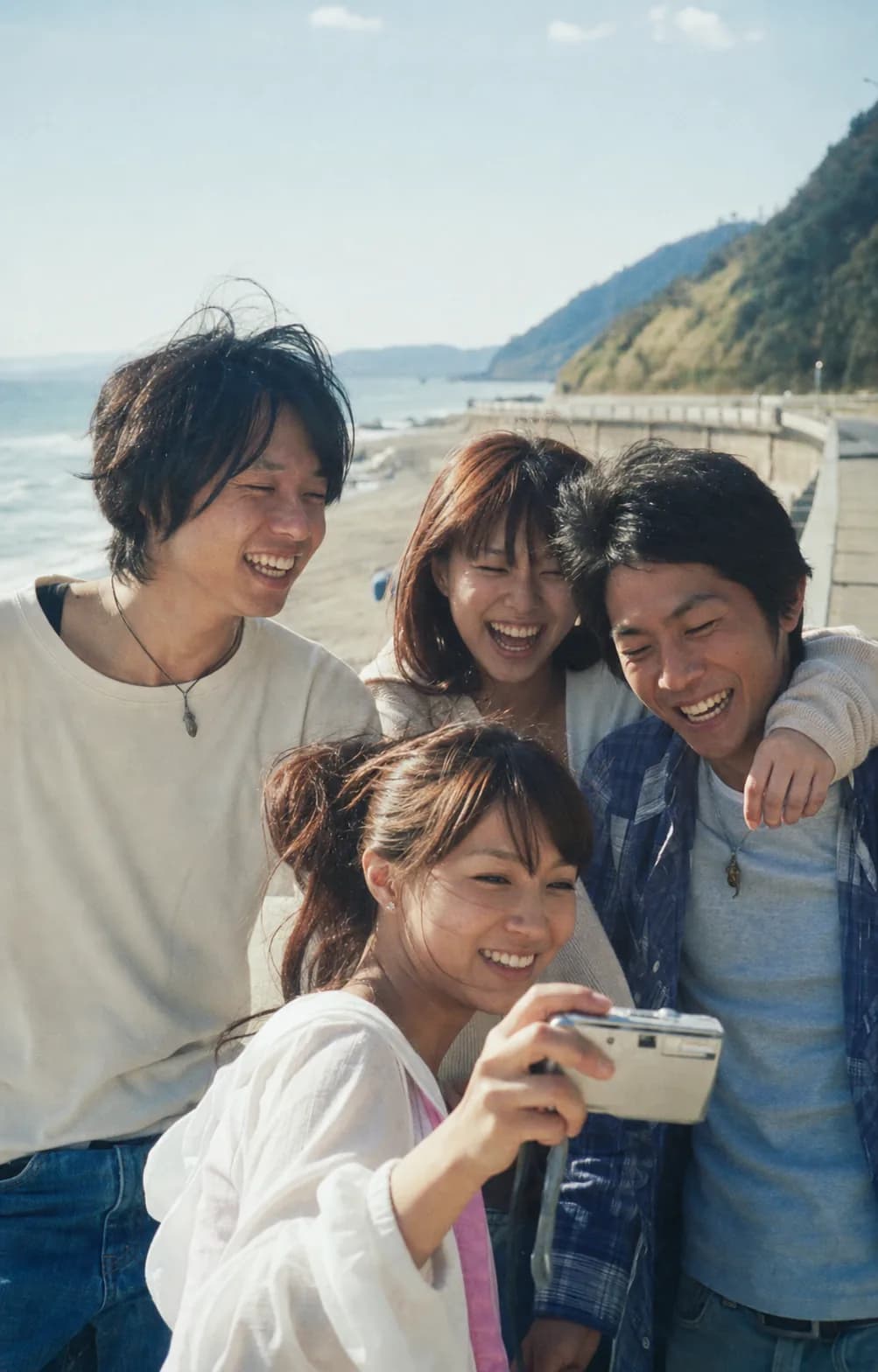 Friends laughing together by the sea